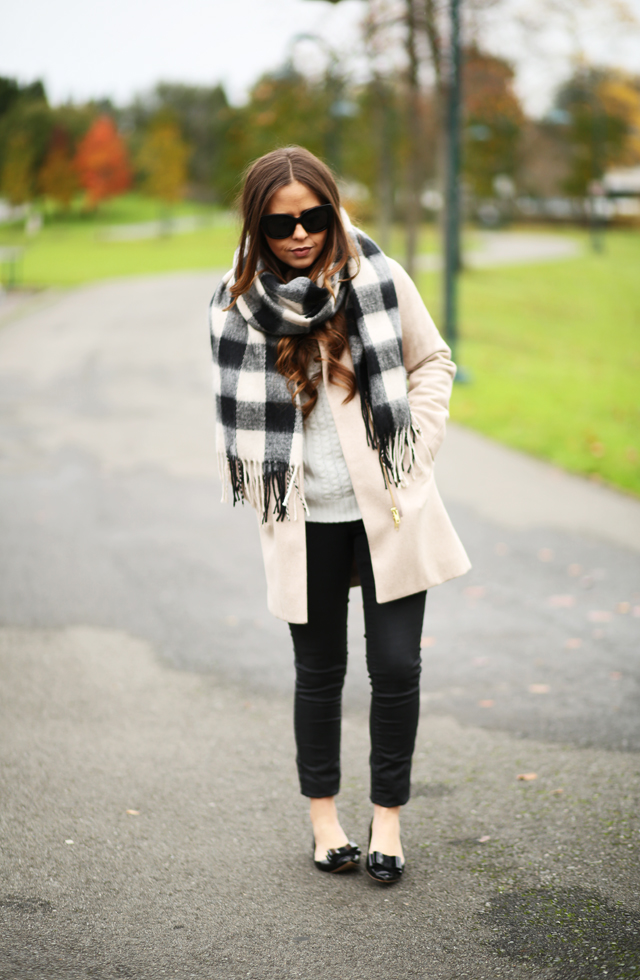 tan coat with black and white buffalo check scarf