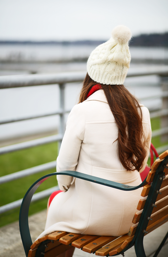 white jcrew coat on a bench