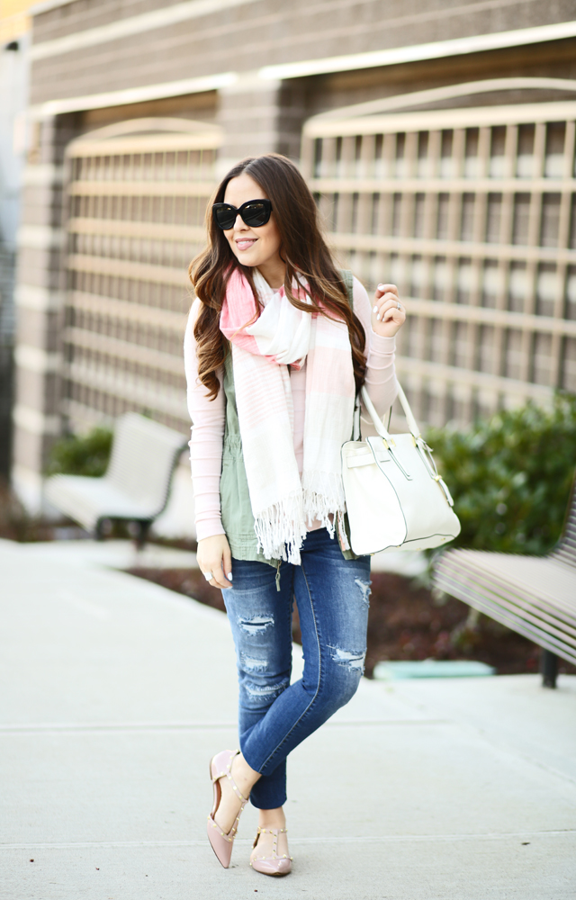 pink striped scarf and sweater ripped jeans and army green vest